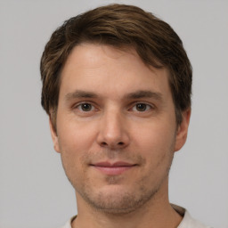 Joyful white young-adult male with short  brown hair and brown eyes