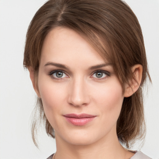 Joyful white young-adult female with medium  brown hair and grey eyes