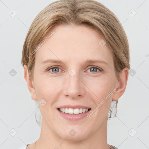 Joyful white young-adult female with short  brown hair and grey eyes