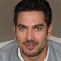 Joyful white adult male with short  black hair and brown eyes