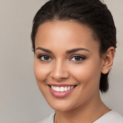 Joyful white young-adult female with medium  brown hair and brown eyes