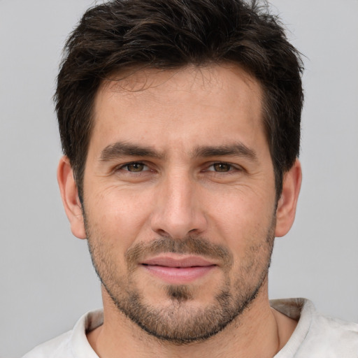 Joyful white young-adult male with short  brown hair and brown eyes