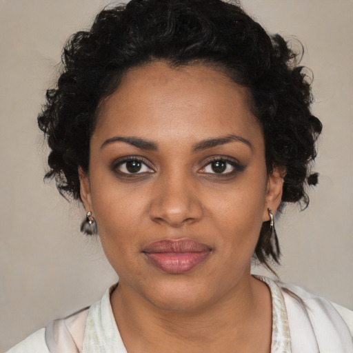 Joyful black young-adult female with medium  brown hair and brown eyes
