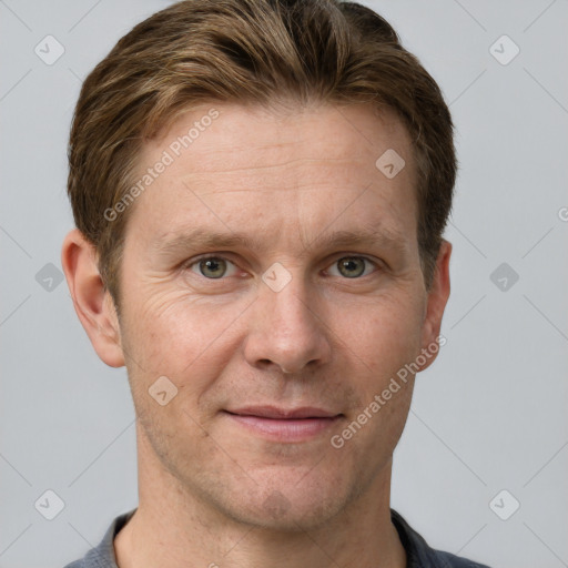 Joyful white adult male with short  brown hair and grey eyes