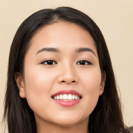 Joyful asian young-adult female with long  brown hair and brown eyes