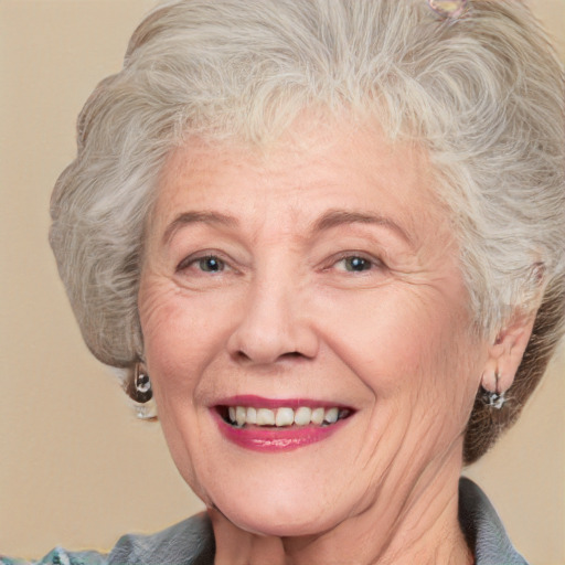 Joyful white middle-aged female with medium  blond hair and blue eyes