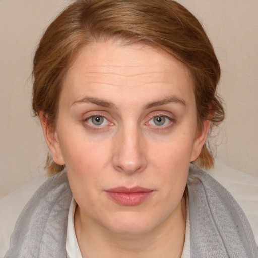 Joyful white young-adult female with medium  brown hair and blue eyes