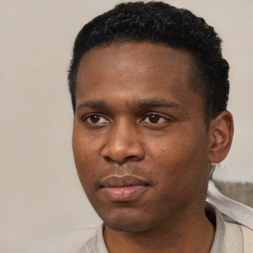 Neutral black young-adult male with short  black hair and brown eyes
