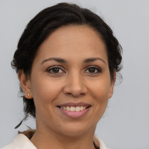 Joyful latino young-adult female with medium  brown hair and brown eyes