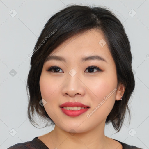 Joyful asian young-adult female with medium  black hair and brown eyes