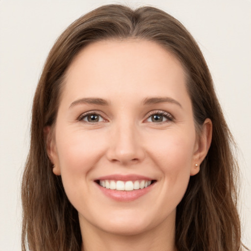 Joyful white young-adult female with long  brown hair and brown eyes