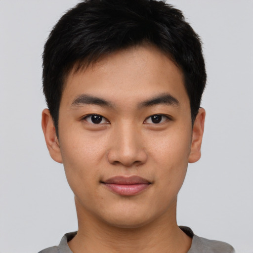 Joyful asian young-adult male with short  black hair and brown eyes