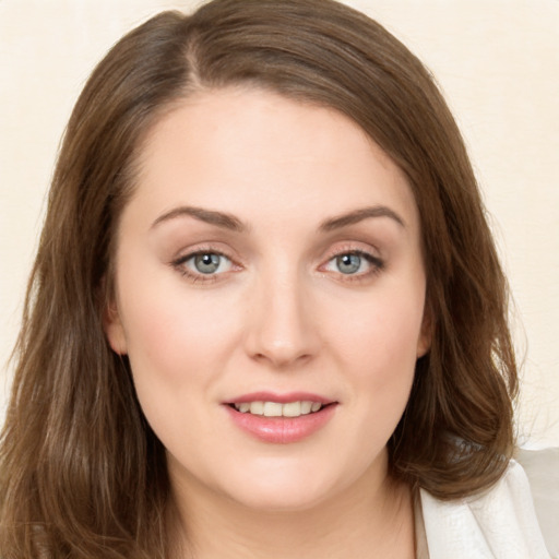 Joyful white young-adult female with long  brown hair and green eyes