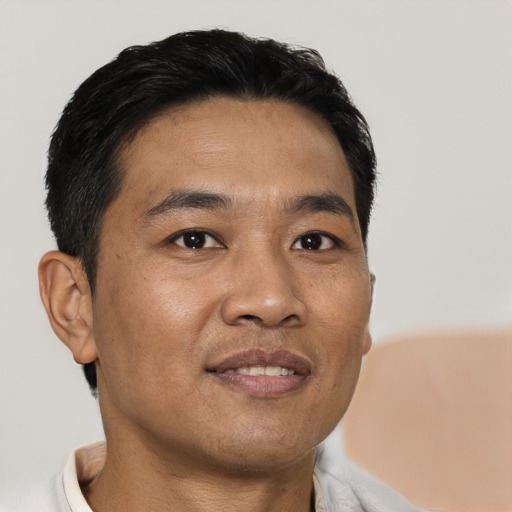 Joyful asian young-adult male with short  black hair and brown eyes