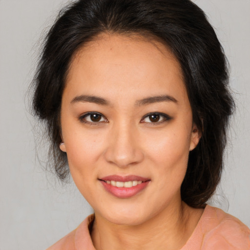 Joyful white young-adult female with medium  brown hair and brown eyes