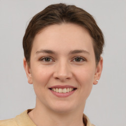 Joyful white young-adult female with short  brown hair and grey eyes