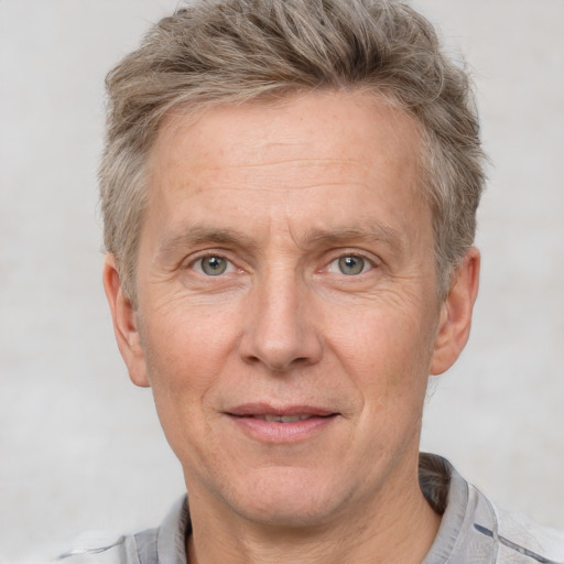 Joyful white middle-aged male with short  brown hair and grey eyes