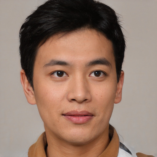 Joyful asian young-adult male with short  brown hair and brown eyes