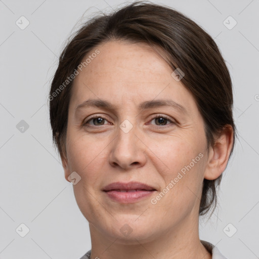 Joyful white adult female with medium  brown hair and grey eyes