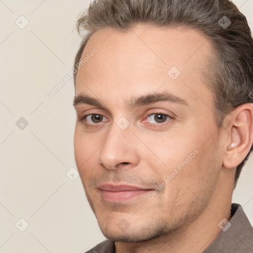 Joyful white adult male with short  brown hair and brown eyes