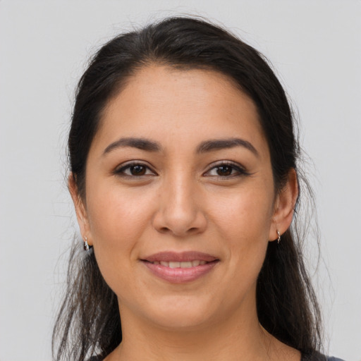 Joyful latino young-adult female with long  brown hair and brown eyes