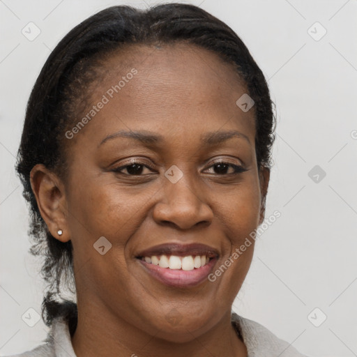 Joyful black adult female with medium  brown hair and brown eyes