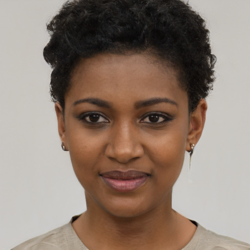 Joyful black young-adult female with short  black hair and brown eyes