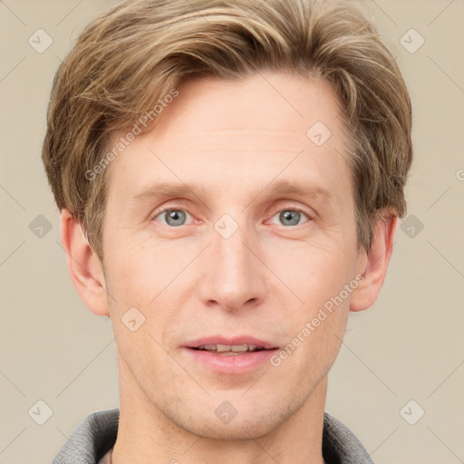 Joyful white adult male with short  brown hair and grey eyes