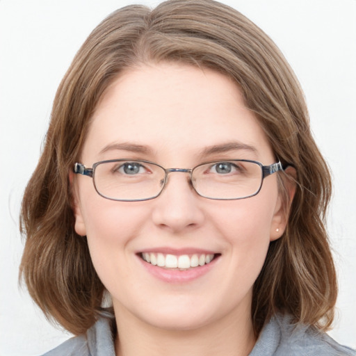 Joyful white young-adult female with medium  brown hair and blue eyes