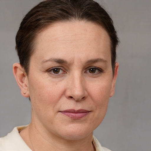 Joyful white adult female with short  brown hair and brown eyes