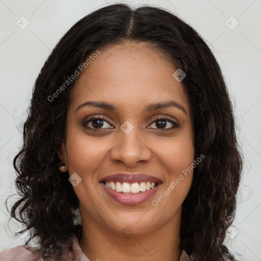 Joyful black young-adult female with long  brown hair and brown eyes