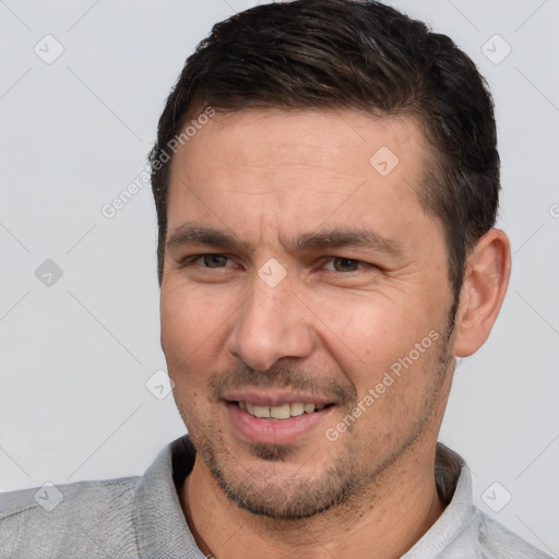 Joyful white adult male with short  brown hair and brown eyes