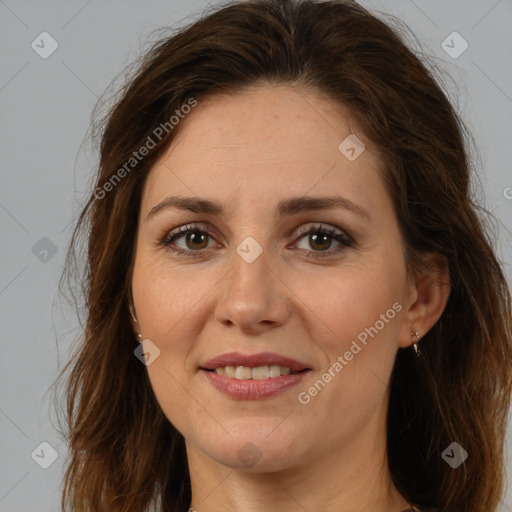 Joyful white adult female with long  brown hair and brown eyes