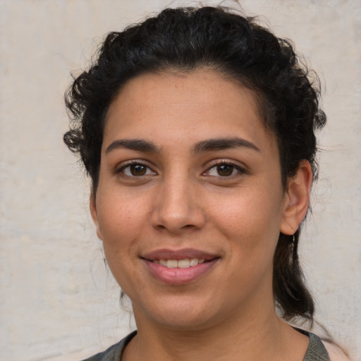 Joyful latino young-adult female with short  brown hair and brown eyes