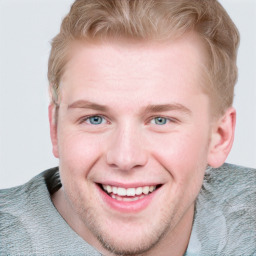 Joyful white young-adult male with short  brown hair and blue eyes