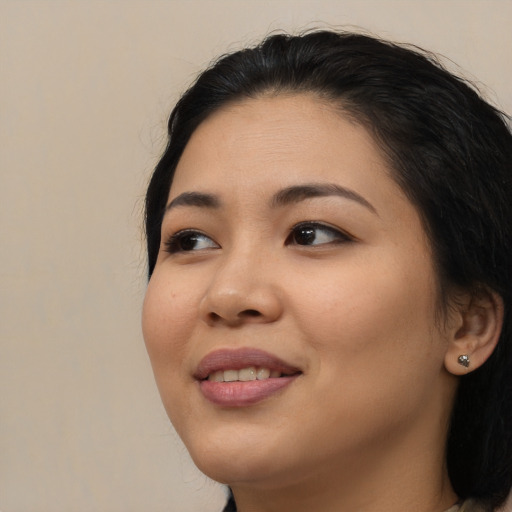 Joyful asian young-adult female with long  brown hair and brown eyes