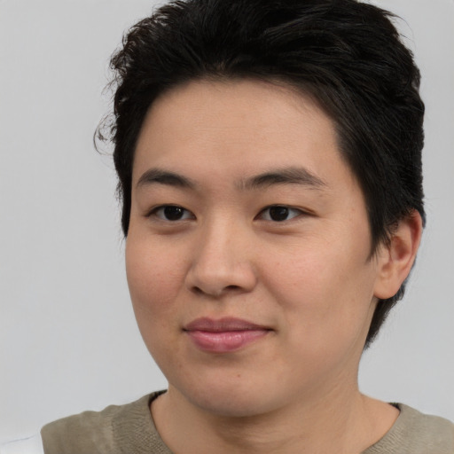 Joyful asian young-adult female with short  brown hair and brown eyes