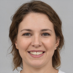 Joyful white young-adult female with medium  brown hair and brown eyes