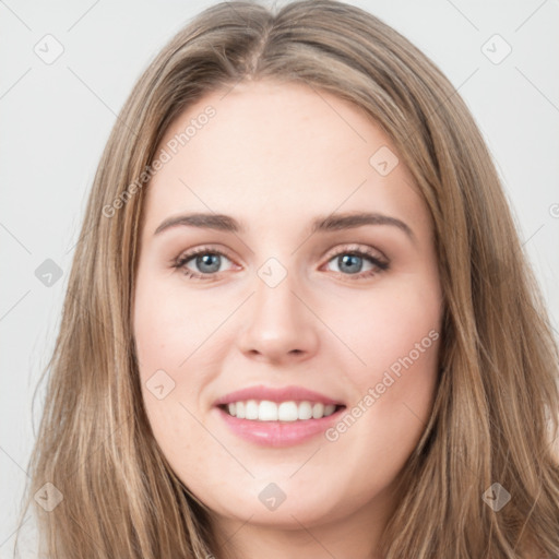 Joyful white young-adult female with long  brown hair and green eyes