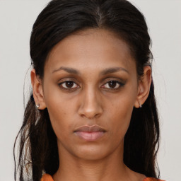 Neutral black young-adult female with long  brown hair and brown eyes