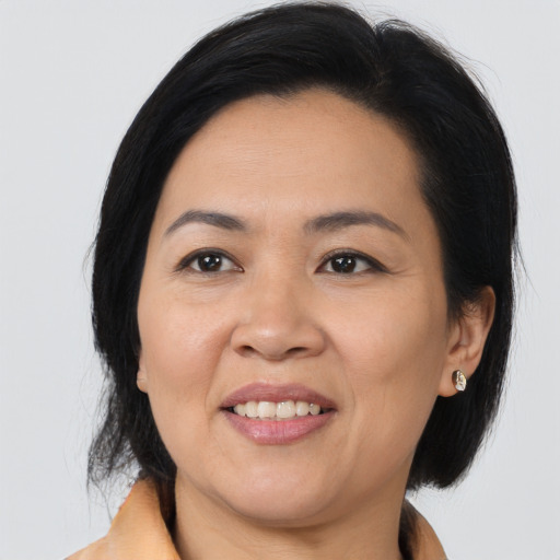 Joyful asian adult female with medium  black hair and brown eyes