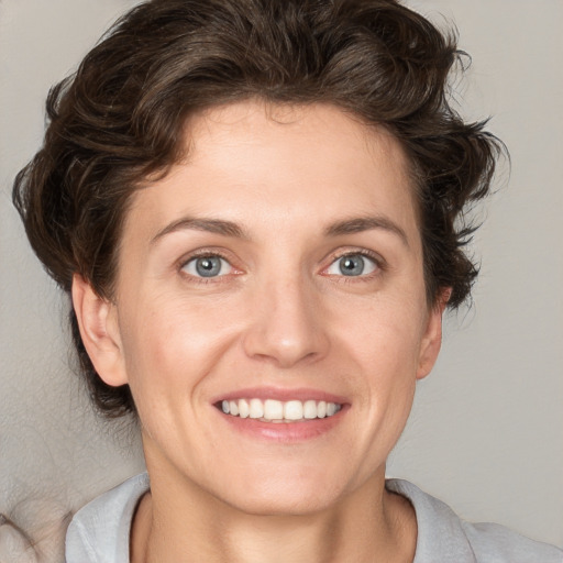 Joyful white young-adult female with medium  brown hair and blue eyes