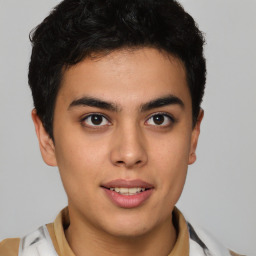 Joyful latino young-adult male with short  brown hair and brown eyes