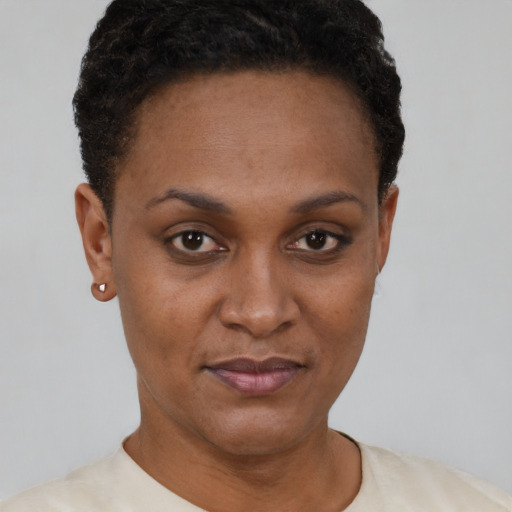 Joyful black young-adult female with short  brown hair and brown eyes