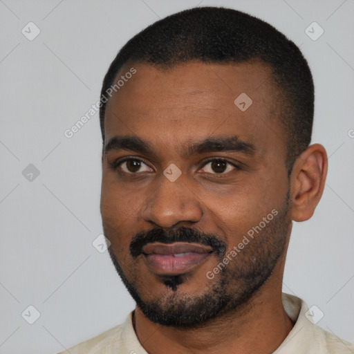 Joyful black young-adult male with short  black hair and brown eyes