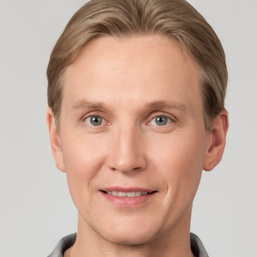 Joyful white adult male with short  brown hair and grey eyes