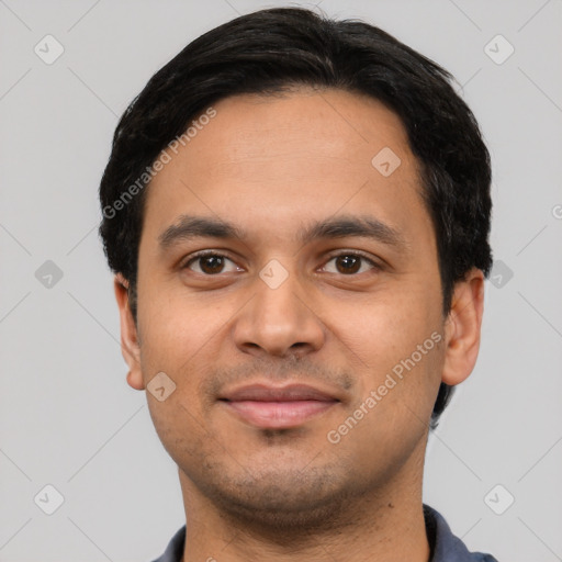 Joyful latino young-adult male with short  black hair and brown eyes