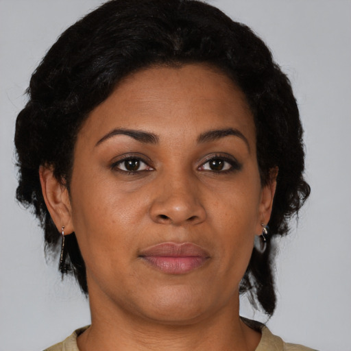 Joyful latino adult female with short  brown hair and brown eyes