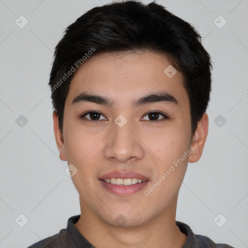 Joyful asian young-adult male with short  black hair and brown eyes