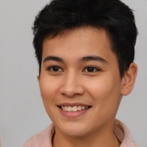Joyful asian young-adult male with short  brown hair and brown eyes